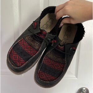 Black and red hey dude slip ons